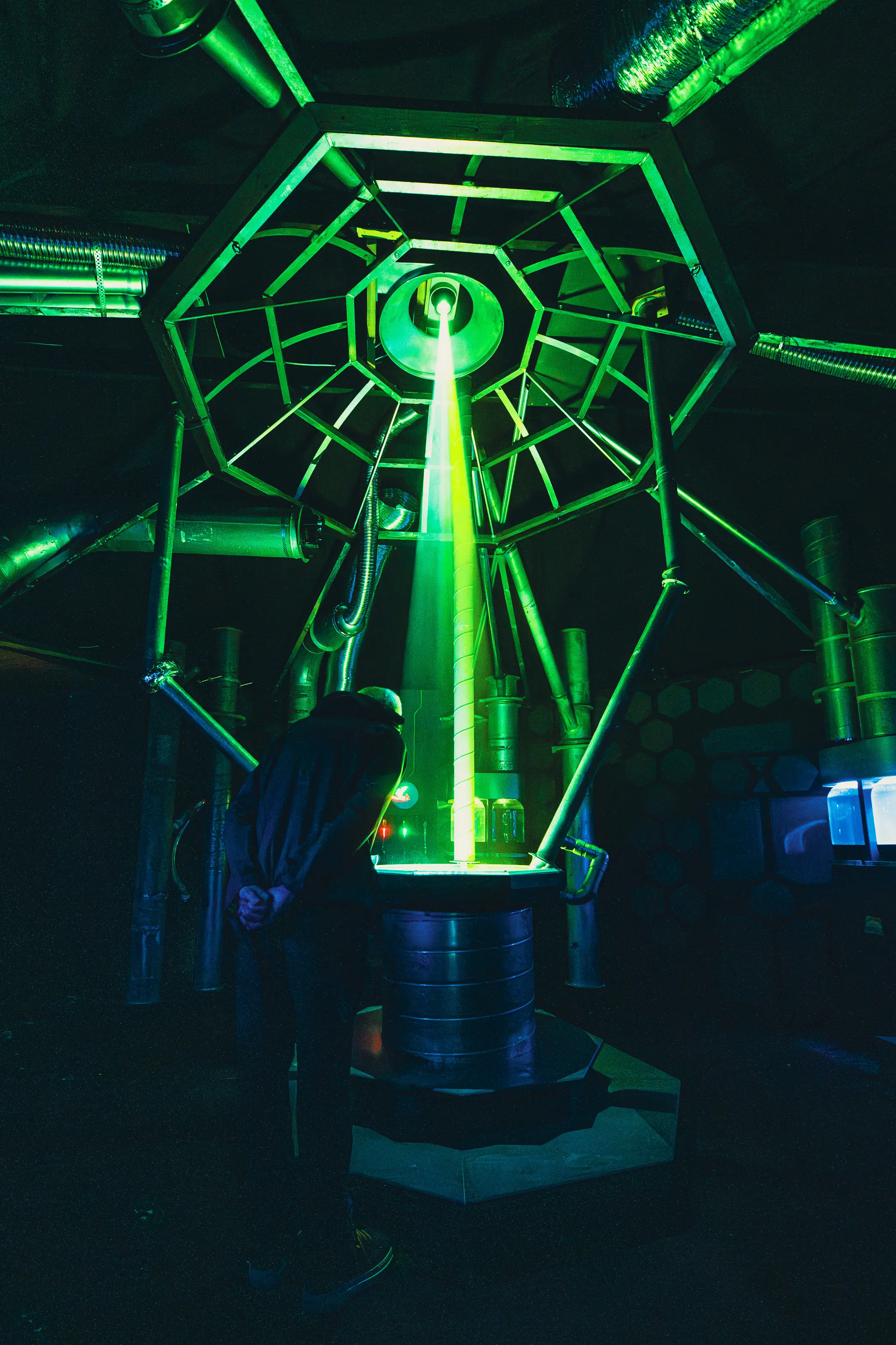 Tall shot of pipework and atmospheric lighting inside the Concoct laboratory-style environment