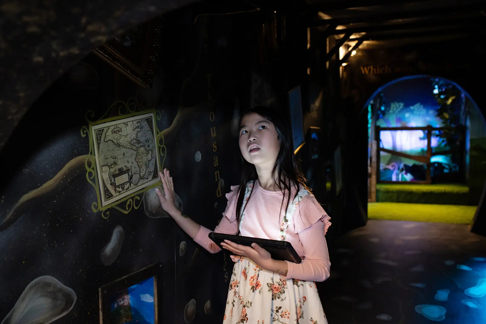 Child interacting with an oversized Alice-themed prop inside the Z-Arts experience